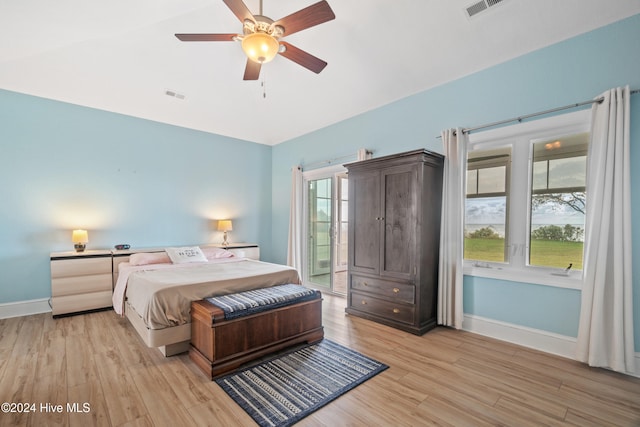 bedroom with light hardwood / wood-style floors, access to outside, and ceiling fan