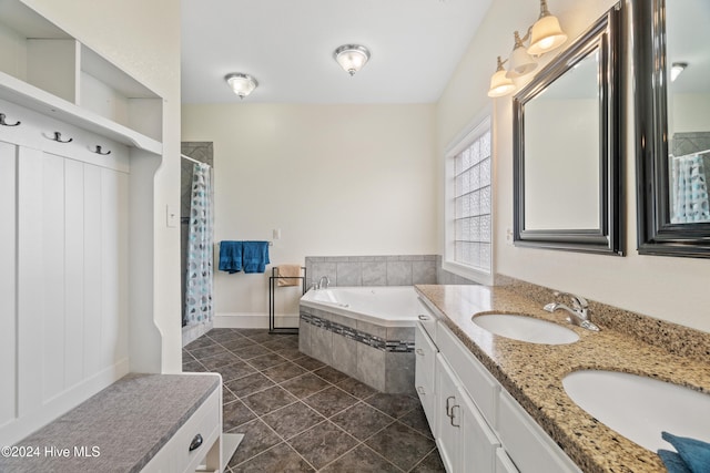 bathroom featuring vanity, independent shower and bath, and tile patterned floors