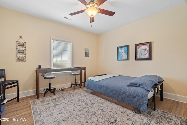 bedroom featuring hardwood / wood-style flooring and ceiling fan