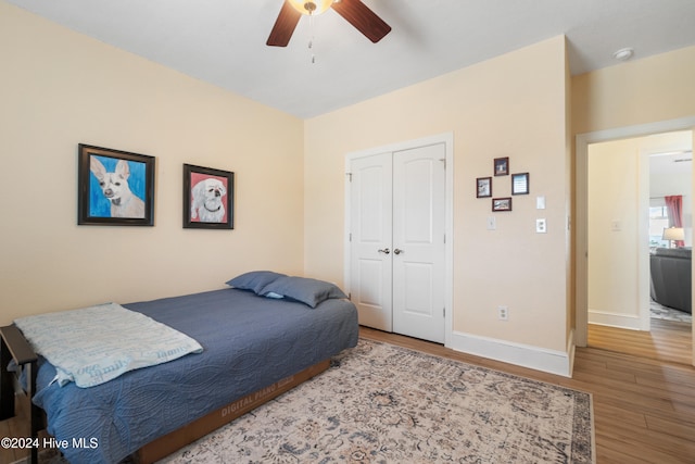 bedroom with a closet, ceiling fan, and hardwood / wood-style floors