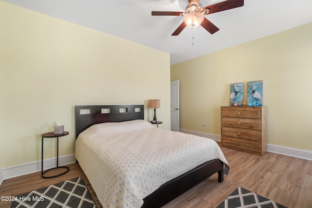 bedroom with light hardwood / wood-style flooring and ceiling fan