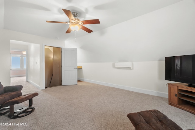 sitting room with an AC wall unit, vaulted ceiling, light carpet, and ceiling fan