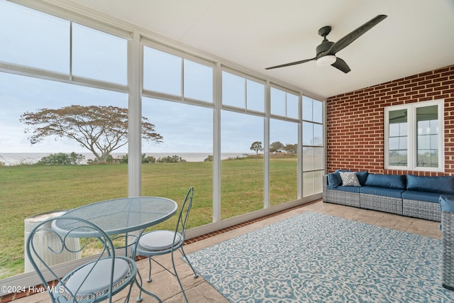 sunroom / solarium featuring ceiling fan