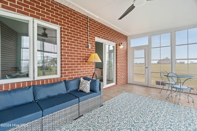 sunroom featuring ceiling fan