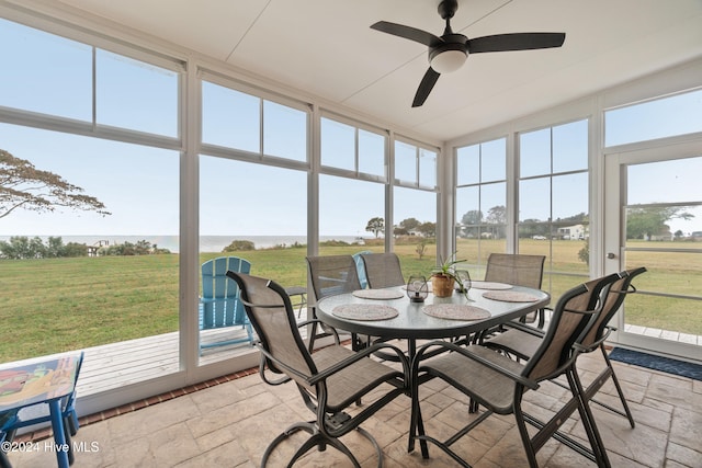 sunroom featuring ceiling fan, a healthy amount of sunlight, and a rural view