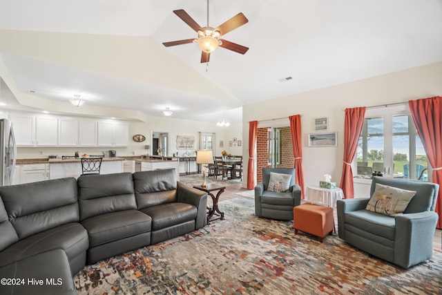 living room featuring high vaulted ceiling, wood-type flooring, and ceiling fan with notable chandelier