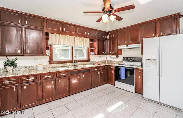 kitchen featuring white appliances, ceiling fan, and light tile patterned floors