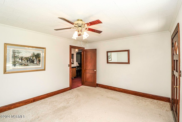 unfurnished room with ceiling fan, crown molding, and light colored carpet