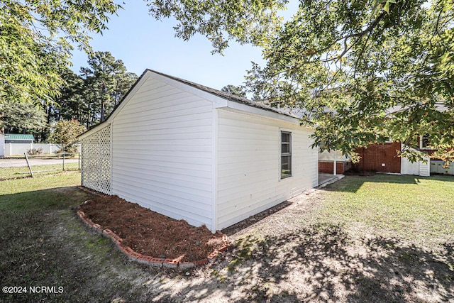 view of side of property with a lawn