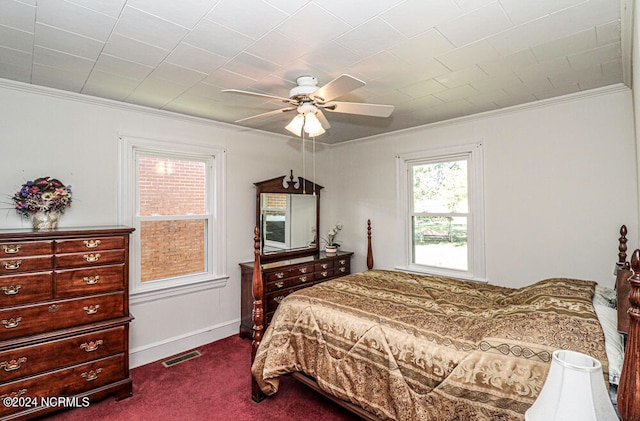 carpeted bedroom with ornamental molding and ceiling fan