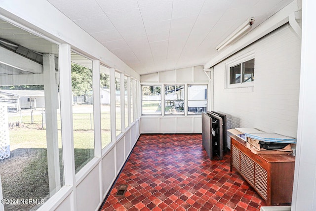 sunroom featuring vaulted ceiling