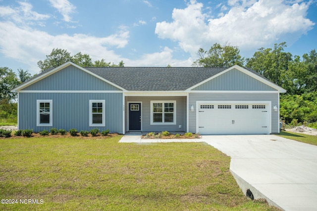 view of front of property with a front lawn and a garage