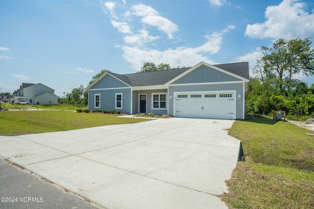 view of front of home featuring a front yard and a garage