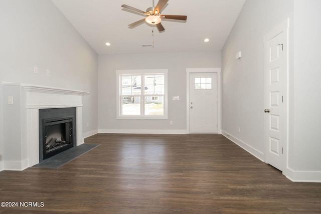 unfurnished living room with ceiling fan, vaulted ceiling, and dark hardwood / wood-style flooring