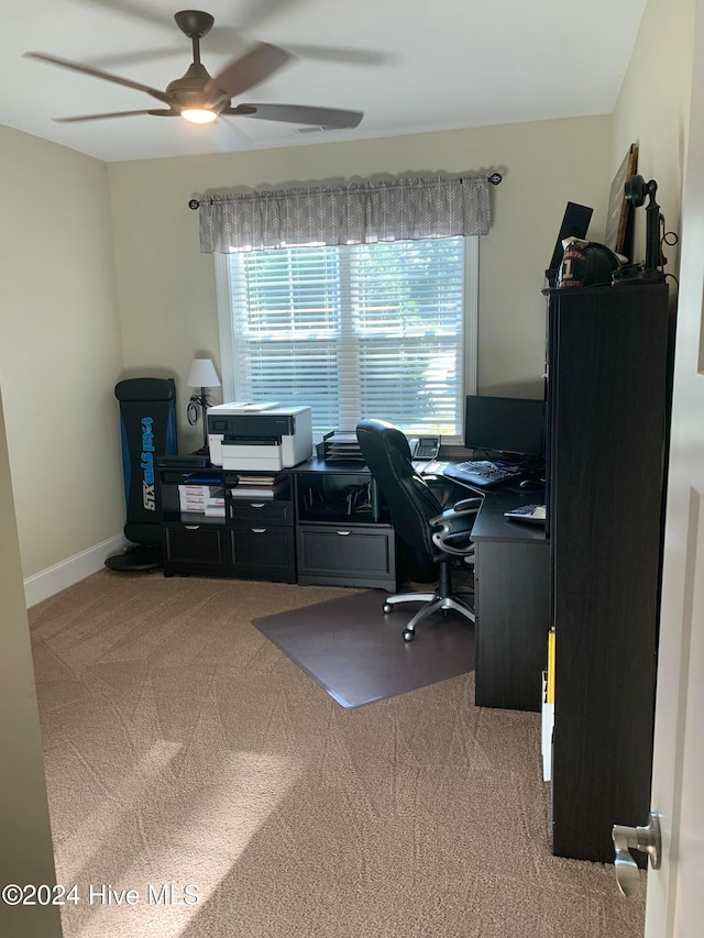 home office with light carpet and ceiling fan