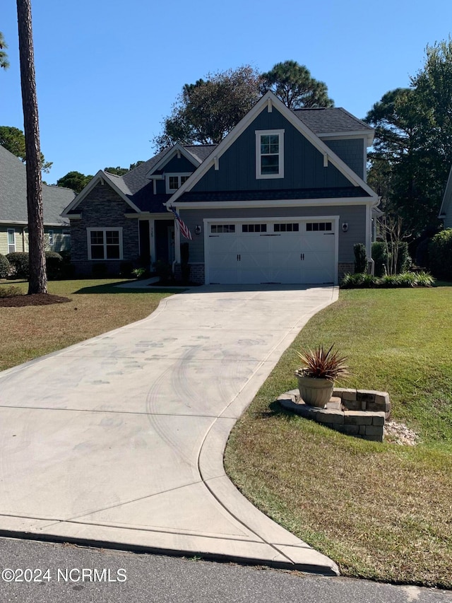 view of front of property with a front lawn and a garage