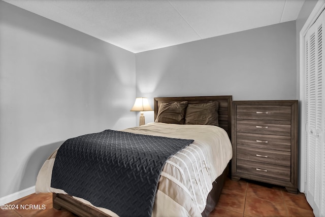 bedroom featuring a closet and dark tile patterned floors