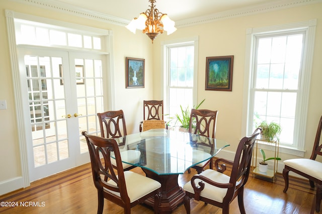 dining space featuring crown molding, french doors, and hardwood / wood-style flooring