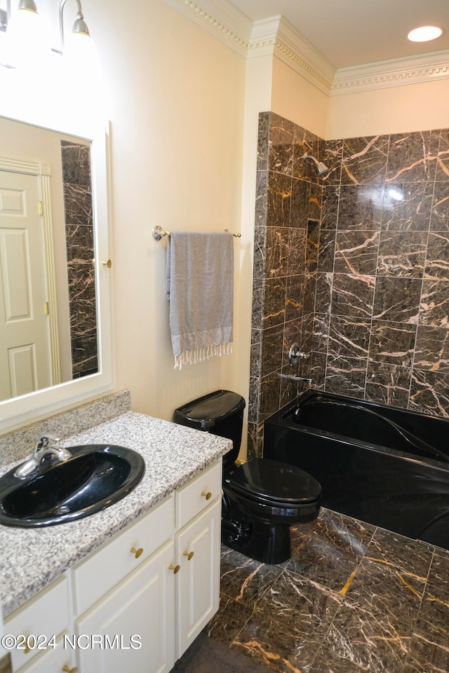 full bathroom with tiled shower / bath, vanity, and toilet