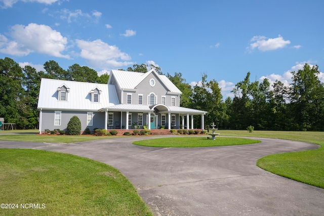 view of front of home featuring covered porch and a front yard