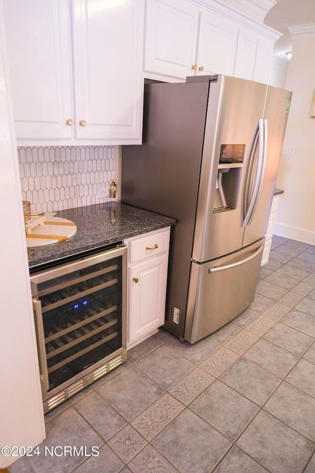 kitchen with light tile patterned floors, white cabinetry, wine cooler, decorative backsplash, and stainless steel fridge with ice dispenser