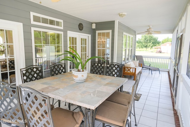 sunroom / solarium featuring ceiling fan and a wealth of natural light