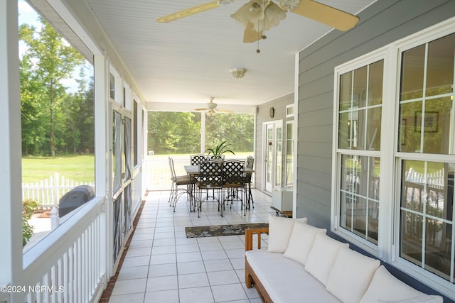 sunroom with plenty of natural light and ceiling fan