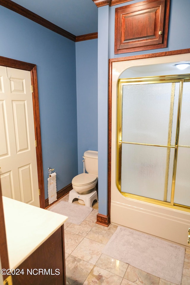 full bathroom with vanity, toilet, ornamental molding, and bath / shower combo with glass door