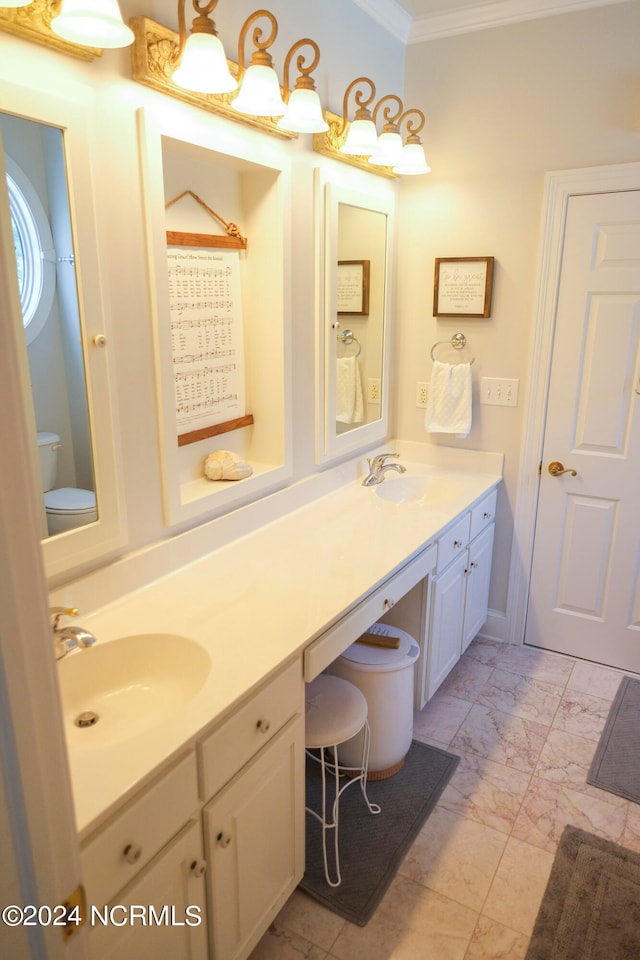 bathroom featuring vanity, ornamental molding, and toilet