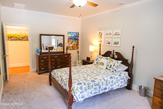 carpeted bedroom with ornamental molding and ceiling fan