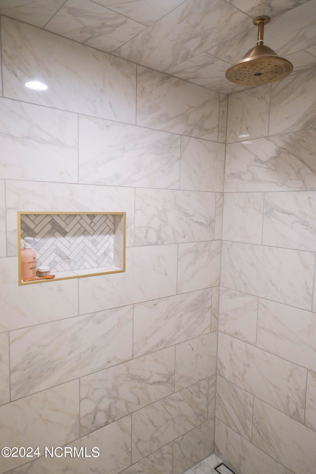 bathroom with tiled shower