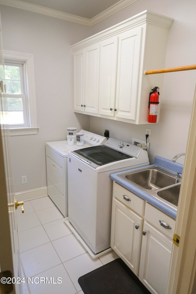 laundry room with sink, washing machine and dryer, cabinets, and ornamental molding