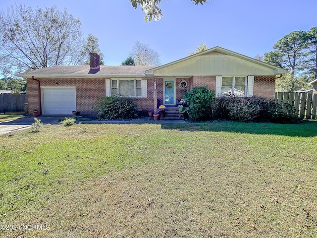 ranch-style house featuring a front lawn and a garage