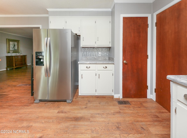 kitchen featuring white cabinets, backsplash, ornamental molding, light hardwood / wood-style floors, and stainless steel refrigerator with ice dispenser