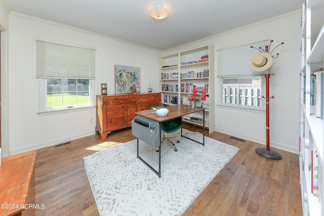 home office featuring ornamental molding and hardwood / wood-style floors