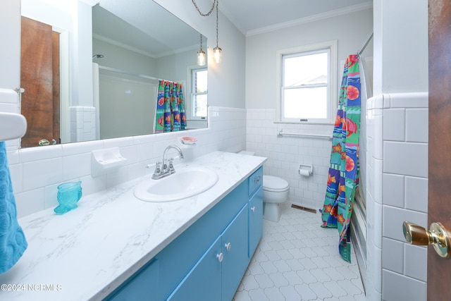 bathroom with tile walls, toilet, ornamental molding, vanity, and tile patterned floors