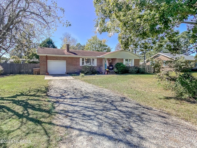 single story home featuring a front lawn and a garage