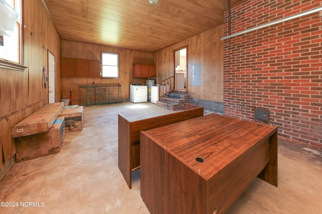 office with wooden ceiling, electric panel, separate washer and dryer, and wooden walls