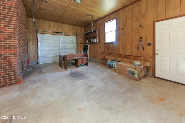 garage featuring wooden walls and wooden ceiling