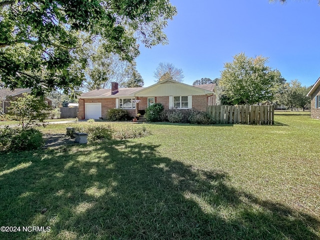 ranch-style home featuring a front lawn and a garage