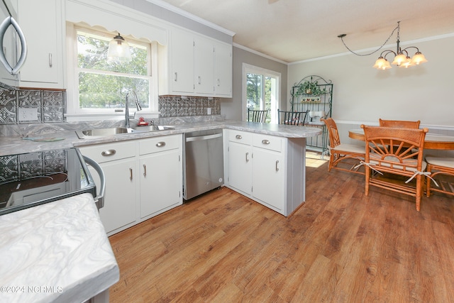 kitchen with sink, white cabinetry, decorative light fixtures, and stainless steel appliances