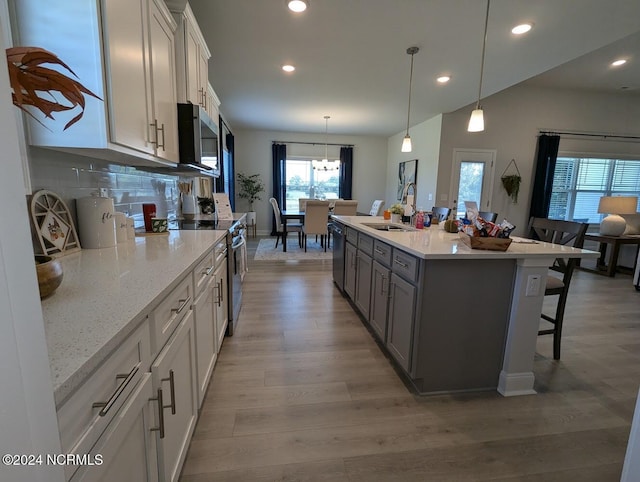 1491 Pecan Drive Model Home, Nashville, NC 27856 - kitchen featuring a breakfast bar, appliances with stainless steel finishes, recessed lighting, and a sink