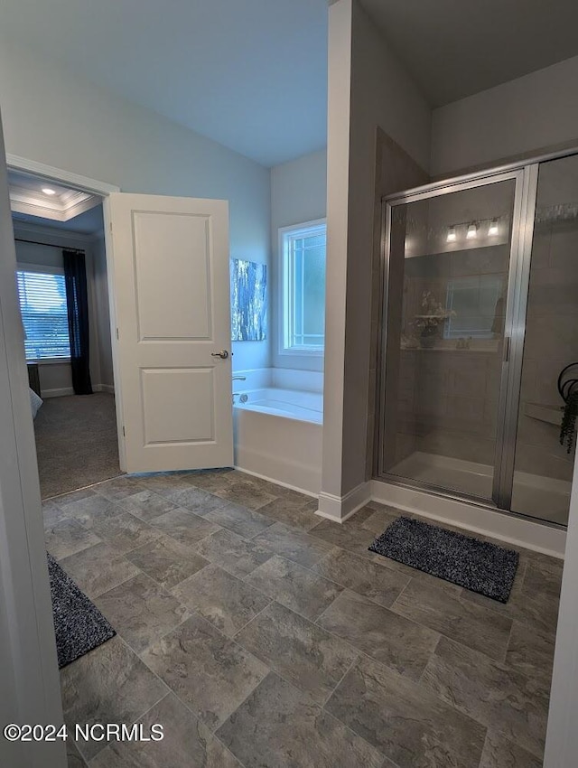 bathroom featuring separate shower and tub