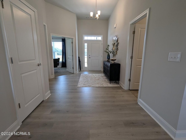 1491 Pecan Drive Model Home, Nashville, NC 27856 - entryway featuring baseboards, wood finished floors, and a chandelier