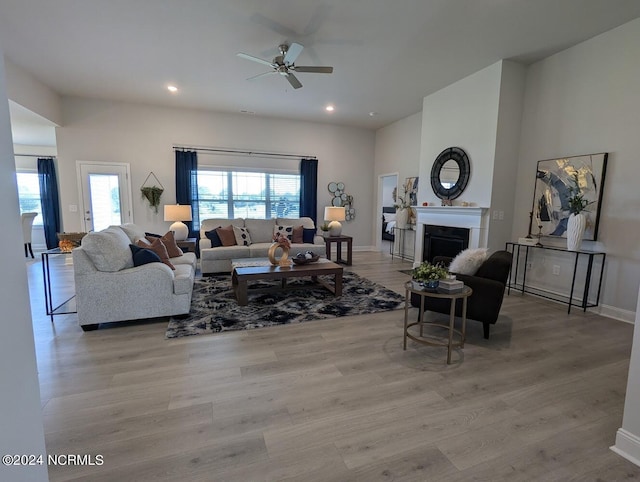 living room with light hardwood / wood-style floors and ceiling fan