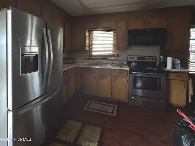 kitchen featuring sink, dark hardwood / wood-style flooring, and appliances with stainless steel finishes