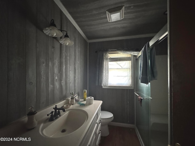 bathroom with walk in shower, crown molding, toilet, wooden walls, and vanity