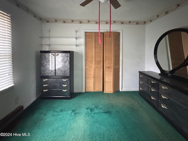 unfurnished bedroom featuring ceiling fan, a closet, and dark carpet