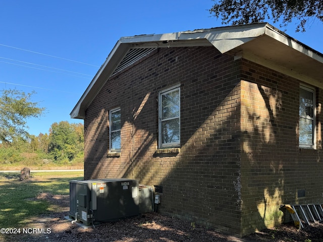 view of side of home featuring central AC