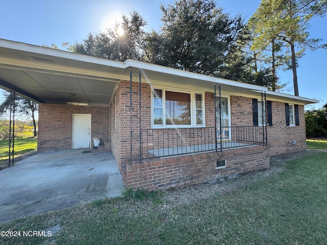 view of front of property with a porch and a carport